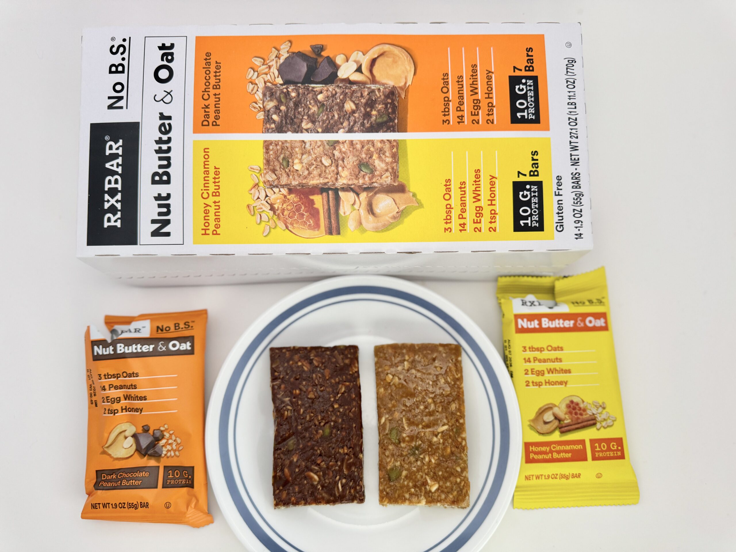 A 14-count variety pack box of RXBAR Nut Butter & Oat bars from Costco, featuring Honey Cinnamon and Dark Chocolate Peanut Butter flavors.