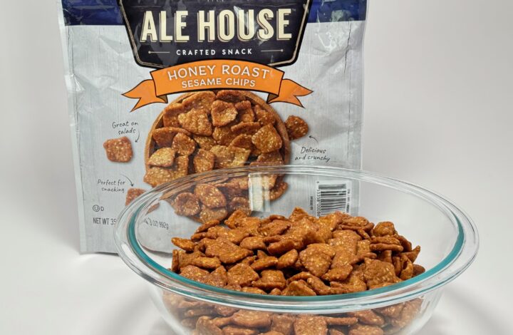Ale House Crafted Honey Roast Sesame Chips bag displayed next to a glass bowl overflowing with the golden brown chips.