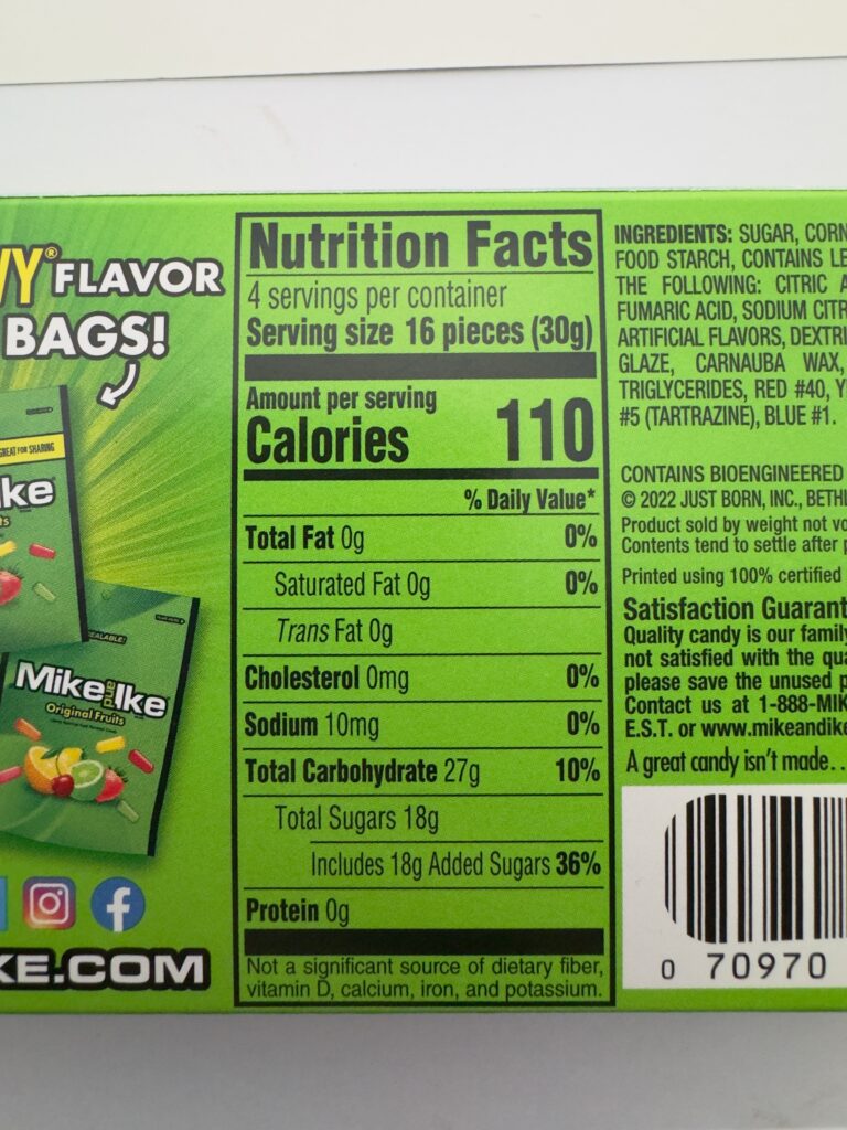 A close-up of the Nutrition Facts panel for Mike and Ike Original Fruits showing 110 calories and 18 grams of added sugar per serving.