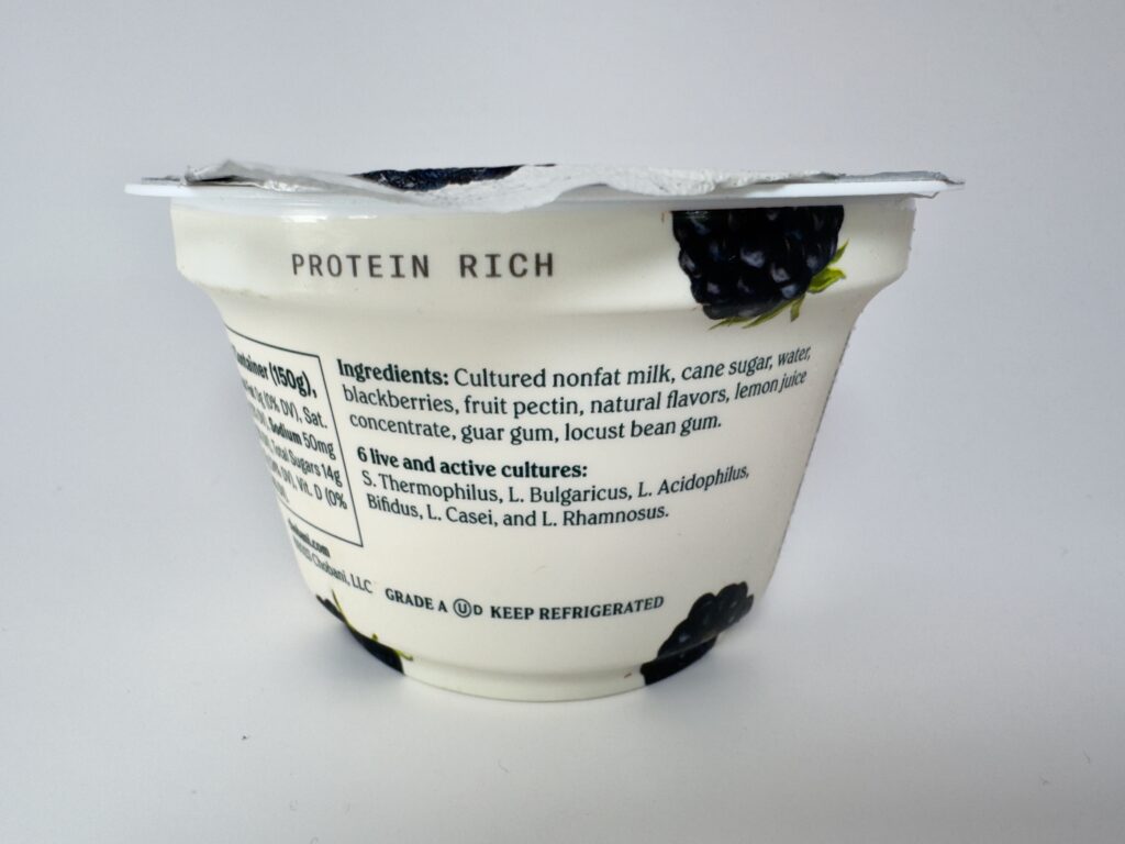 Side view of a Chobani Blackberry Greek Yogurt cup showing the ingredients list and the 6 live and active cultures.